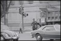 A police officer wearing a gas mask stands in the intersection near the National Archives as traffic resumes during the May Day protests, 03 May 1971