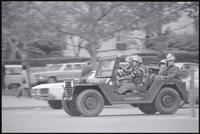 Military police ride a Jeep through downtown Washington, DC during the May Day protests, 03 May 1971