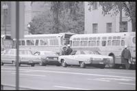 Police approaching a line of buses on Constitution Ave near the Federal Trade Commission during the May Day protests, 03 May 1971