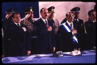 President Alfredo Cristiani, former President José Napoleón Duarte, and Vice President José Francisco Merino López stand for the national anthem at the inauguration ceremony, San Salvador, El Salvador
