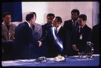 Former President José Napoleón Duarte and President Alfredo Cristiani shake hands at inauguration ceremony, San Salvador, El Salvador