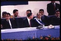 President Alfredo Cristiani sits next to his Vice President José Francisco Merino López and former President José Napoleón Duarte at his swearing in, San Salvador, El Salvador