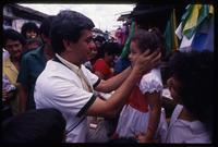 Fidel Chávez Mena, a presidential candidate from the Christian Democratic Party, embraces a child during a campaign stop, El Salvador