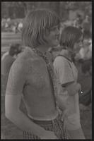 A young woman and a shirtless man covered in mud and wearing a tie gather at Dupont Circle in Washington, D.C., undated