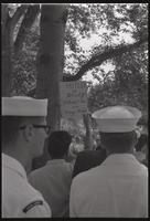 Someone holds a flag comparing Chicago Mayor Richard J. Daley to Adolf Hitler after the police brutality incidents at the Democratic National Convention in Chicago, Lafayette Park, 31 August 1968