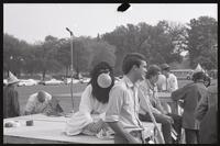 A costumed demonstrator sits on a platform set up on the National Mall with others standing around him during demonstrations of the House of Un-American Activities Committee hearings, 03 October 1968