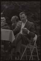 Former U.S. Representative Adam Clayton Powell sits at a table and smokes, American University, 13 October 1968
