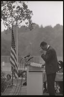 At an event, former U.S. Representative Adam Clayton Powell bows his head during his address to a crowd at American University, 13 October 1968