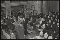 Speakers at the Unity Day Rally, hosted in the Mayflower Hotel, sit at the back of the stage while other hosts and musicians stand at the front of the stage, Washington, D.C., 10 November 1968