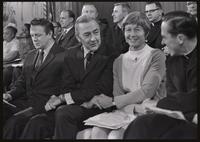 Senator Eugene McCarthy clasps hands and talks to those sitting next to him at the Unity Day Rally hosted in the Mayflower Hotel, Washington, D.C., 10 November 1968
