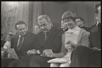 Senator Eugene McCarthy clasps hands with the people sitting next to him at the Unity Day Rally hosted in the Mayflower Hotel, Washington, D.C., 10 November 1968