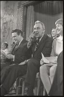 Senator Eugene McCarthy makes a gesture while sitting on stage at the Unity Day Rally hosted in the Mayflower Hotel, Washington, D.C., 10 November 1968