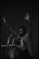 Dick Gregory addresses a crowd of students in the Leonard Center at American University, Washington, D.C., 16 February 1969