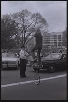 An anti-nuclear demonstrator rides a tall unicycle near the National Mall in Washington, D.C., 06 May 1979