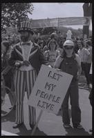 A demonstrator dressed as Uncle Sam holds a sign that says "Let my people live" while participating in an anti-nuclear power demonstration in Washington, D.C., 06 May 1979