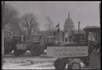 Tractors parked along the street bordering the U.S. Capitol Grounds display protest signs supporting family farms during the American Agriculture Movement's second Tractorcade demonstration in Washington, D.C., 28 February 1979