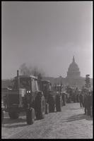Farmers drive their tractors near the U.S. Capitol Building during the American Agriculture Movement's second Tractorcade demonstration in Washington, D.C., 28 February 1979