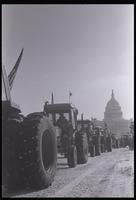 Tractors drive along Pennsylvania Avenue near the U.S. Capitol Building during the American Agriculture Movement's second Tractorcade demonstration in Washington, D.C., 28 February 1979