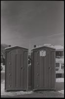 Two portable toilets, one with a sign that says "No shit this is it," sit on the National Mall during the American Agriculture Movement's second Tractorcade demonstration in Washington, D.C., 28 February 1979