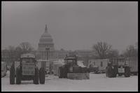 Tractors display protest signs in support of the American farmer while sitting parked on the National Mall near the U.S. Capitol Building during the American Agriculture Movement's second Tractorcade demonstration in Washington, D.C., 28 February 1979