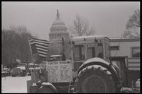 A list of tractor sponsors and an upside-down American flag are displayed on a tractor parked near the National Mall and U.S. Capitol Building during the American Agriculture Movement's second Tractorcade demonstration in Washington, D.C., 28 February 197