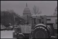 An upside-down American flag and list of tractor sponsors are displayed on a tractor parked near the National Mall and U.S. Capitol Building during the American Agriculture Movement's second Tractorcade demonstration in Washington, D.C., 28 February 1979