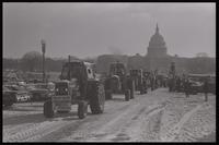A parade of tractors drives along Pennsylvania Avenue near the U.S. Capitol Building during the American Agriculture Movement's second Tractorcade demonstration in Washington, D.C., 28 February 1979