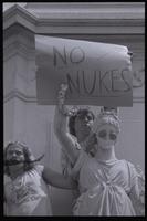 Protesters at an anti-nuclear power demonstration place a protest sign that says "No nukes" on the Victory statue of the Peace Monument in Washington, D.C., 06 May 1979