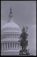 A male demonstrator sits atop the Ulysses S. Grant Memorial on the U.S. Capitol Grounds while others sit around the base during an anti-nuclear power demonstration in Washington, D.C., 06 May 1979