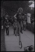 A demonstrator attending the anti-nuclear power demonstration rides a unicycle through crowds of people in Washington, D.C., 06 May 1979