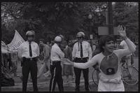 A demonstrator dances in front of three police officers during an anti-nuclear power protest in Washington, D.C., 06 May 1979