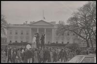 A crowd gathers outside the White House to watch the Committee for a Sane Nuclear Policy stage a mock crucifixion, called the Vietnam Passion Play, Washington, D.C., 06 April 1969