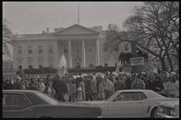 A crowd gathers outside the White House as the Committee for a Sane Nuclear Policy performs a mock crucifixion, called the Vietnam Passion Play, Washington, D.C., 06 April 1969