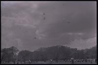 An airplane soars over several kites during the Smithsonian Institution's annual kite carnival on the National Mall, Washington, D.C., 19 April 1969