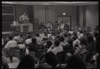 A man from the New AU group speaks to a group of people during a meeting advocating for student parity on faculty committees at American University, Washington, D.C., 24 April 1969