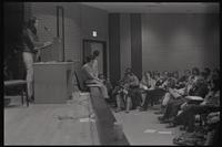 A woman speaks to a crowd at the New AU meeting advocating for student parity on faculty committees at American University, Washington, D.C., 24 April 1969