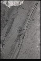 A woman climbs a rocky incline, probably around Washington, D.C., undated