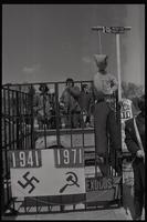 A cage is set up on a trailer with a sign that says "1941, 1971" and has a hanging Soviet leader's effigy at a protest organized by the Jewish Defense League against the treatment of Soviet Jewry, the Ellipse, Washington, D.C., 21 March 1971