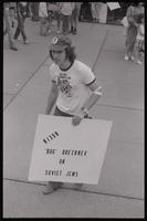 A young man carries a sign urging Nixon to advocate for Soviet Jews during a demonstration outside the U.S. Capitol Building, Washington, D.C., 19 June 1973