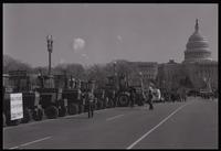 A line of tractors parked along the National Mall in front of the U.S. Capitol Building during the first Tractorcade demonstration in Washington, D.C., 18 January 1978