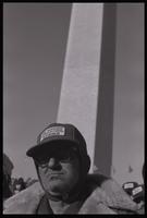 A farmer wearing a hat reading "We Support Agricultural Strike" stands near the Washington Monument during the first Tractorcade demonstration in Washington, D.C., 18 January 1978