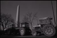 Tractors, displaying protest signs, parked near the Washington Monument in participation with the American Agriculture Movement Farmer's Strike and Tractorcade, 18 January 1978