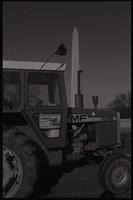 Close-up of a tractor displaying a sign that says "Support National Farm Strike Dec. 14, 1977 for 100% Parity" during the first Tractorcade demonstration, 18 January 1978