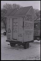 A white outhouse, called "Hotel Carter," on a trailer parked on the National Mall during the second Tractorcade demonstration, 28 February 1979