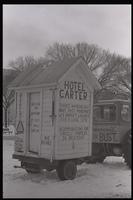A white outhouse, labeled as "Hotel Carter," on display on the National Mall during the second Tractorcade demonstration, 28 February 1979