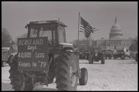 A tractor displays a protest sign reading "Bergland says 40,000 less farms in '79" while occupying the National Mall during the second Tractorcade demonstration, 28 February 1979