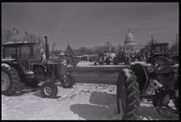 Tractors, displaying American flags, Confederate flags, and American Agriculture Movement flags, are parked on the National Mall near the U.S. Capitol Building as part of the second Tractorcade encampment in Washington, D.C., 28 February 1979