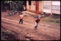 Children walking up hill in area near Yalí