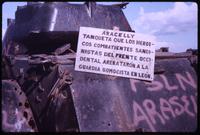 Close view of sign on destroyed tank