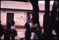 Locals in plaza with Daniel Ortega poster in background 